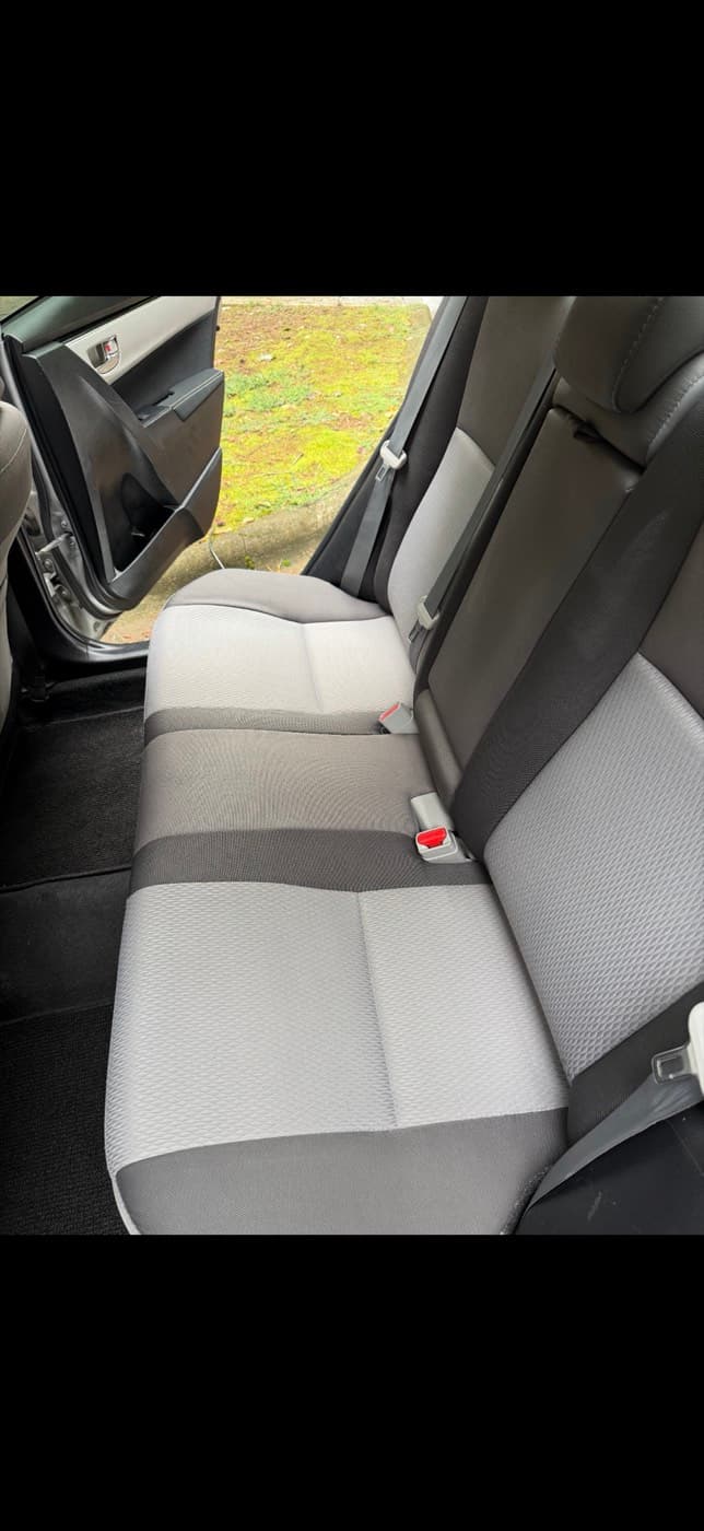 The same grey fabric rear bench seat in a car after steam cleaning