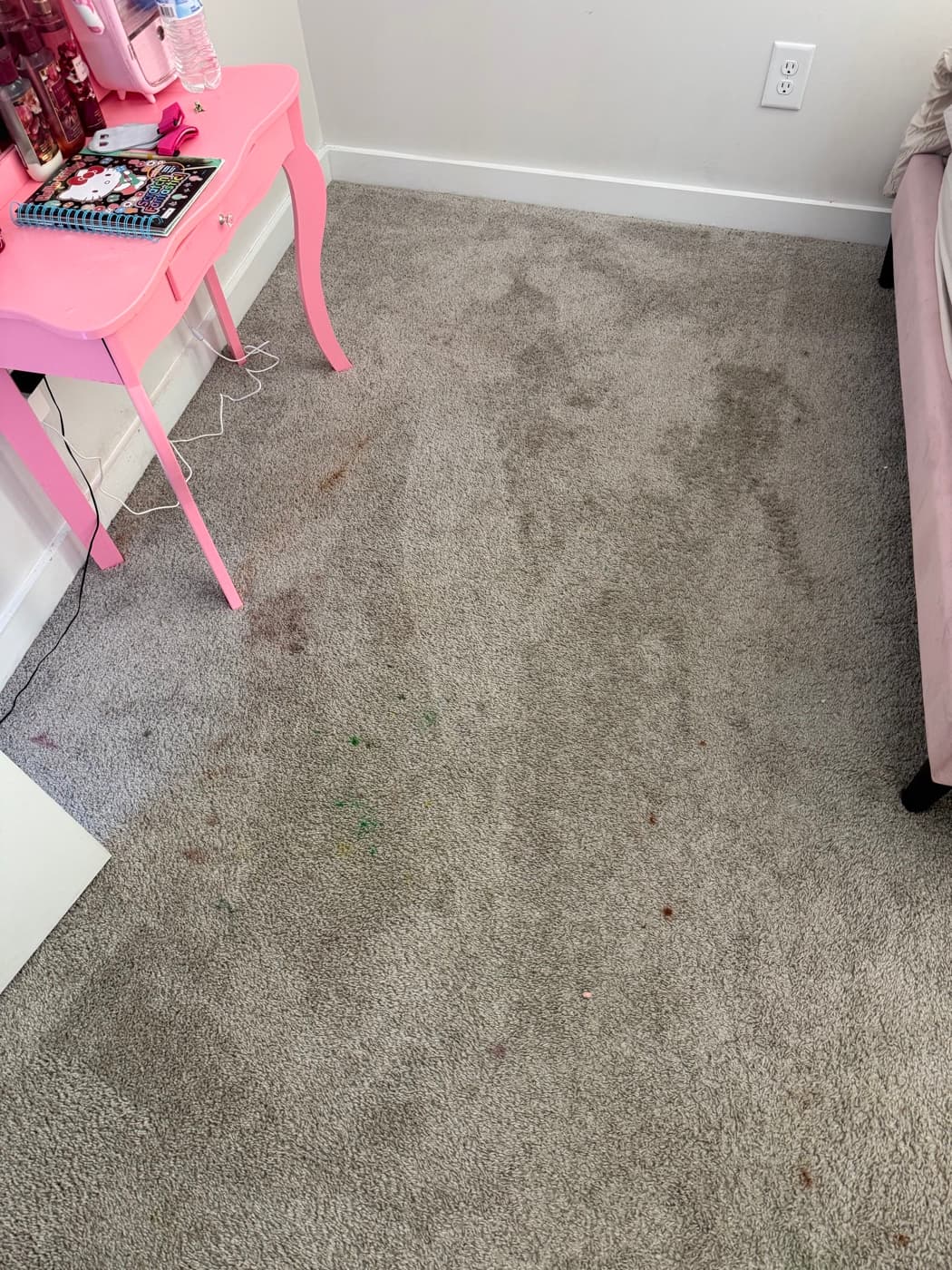 A bedroom carpet with dirt ground into the traffic lane across the middle of the floor, before cleaning