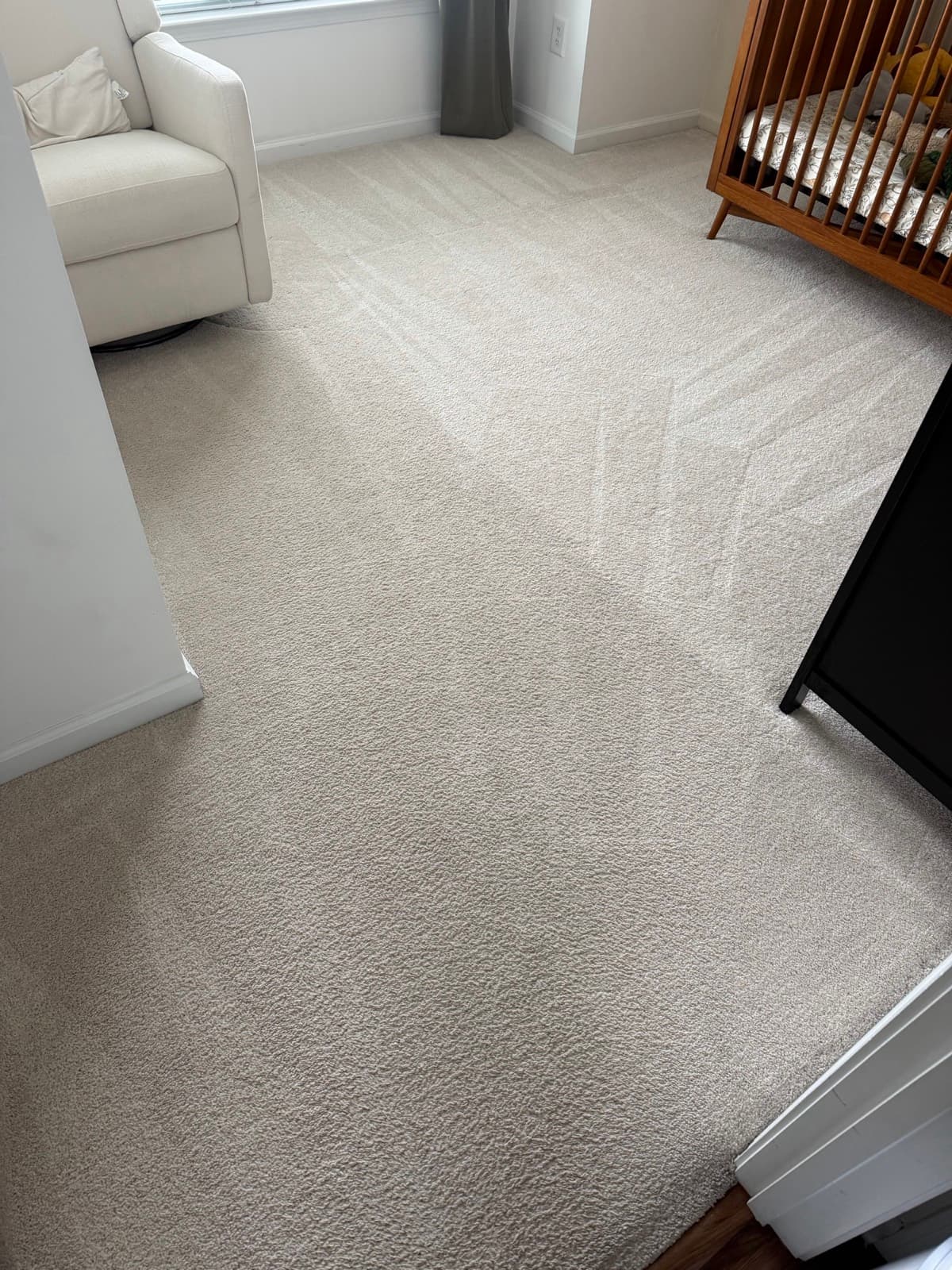 A bedroom carpet after steam cleaning, with fresh vacuum lines across the pile