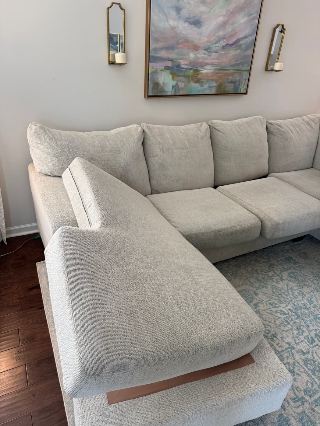 The same light grey sectional sofa after steam cleaning, chaise and seat cushions clean