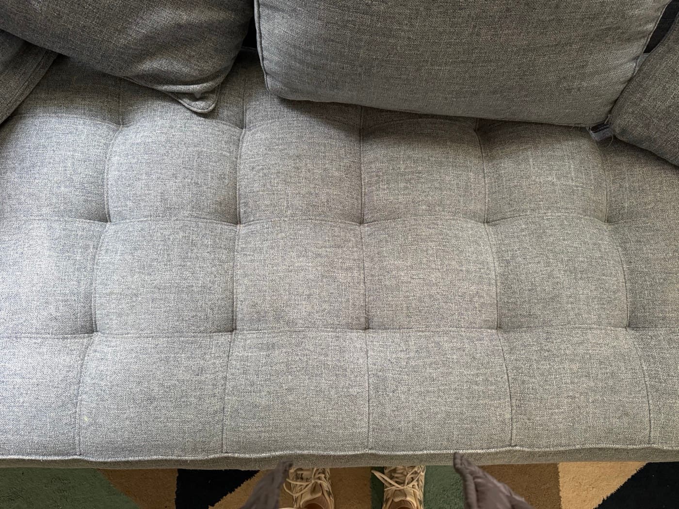 The same grey tufted daybed after steam cleaning