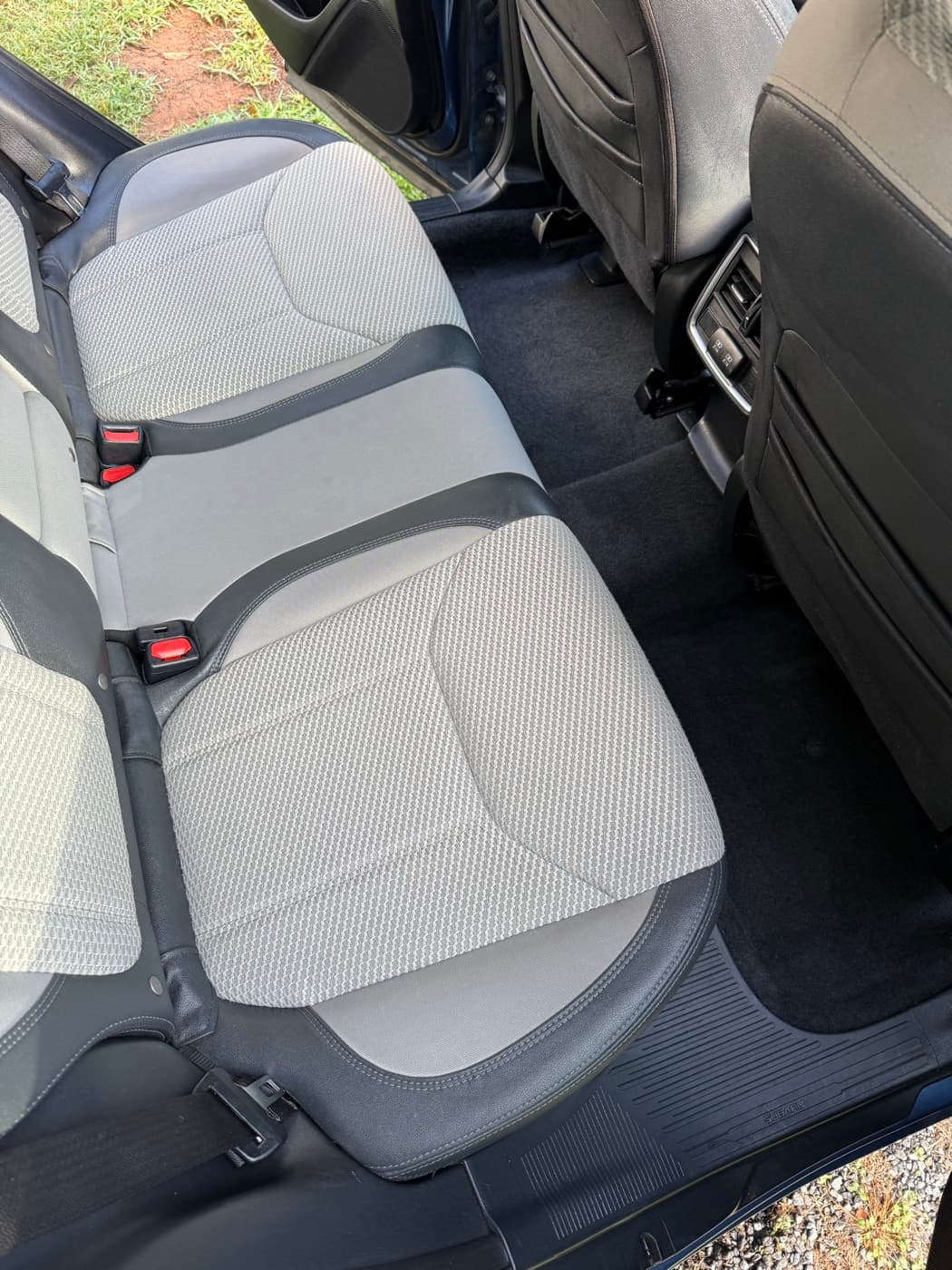 The same cream perforated rear seats in a car after steam cleaning
