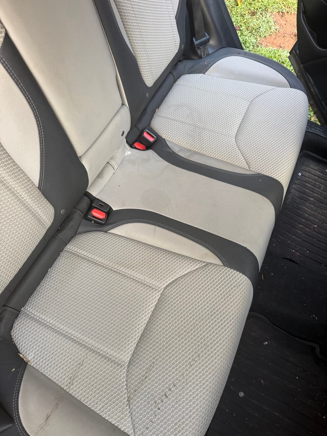 Cream perforated rear seats in a car, before cleaning