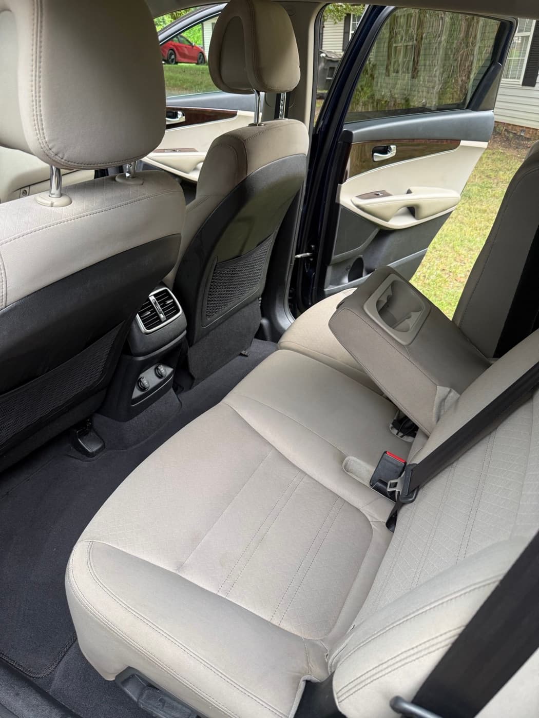 The same cream rear seat in a car after steam cleaning