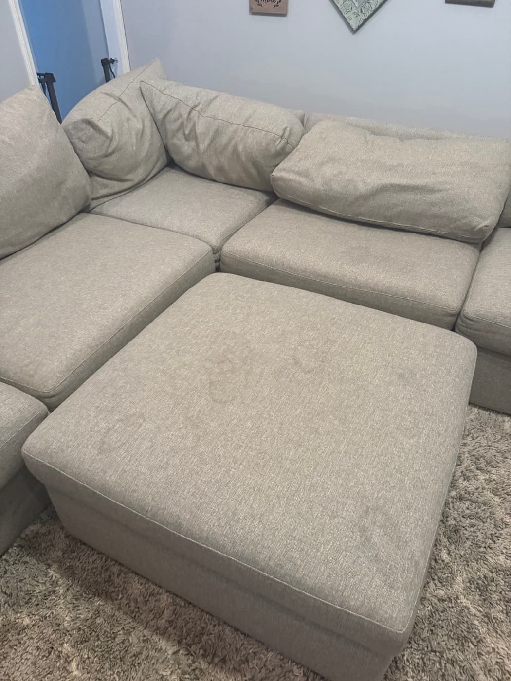 A cream sofa back and seat cushions, before cleaning