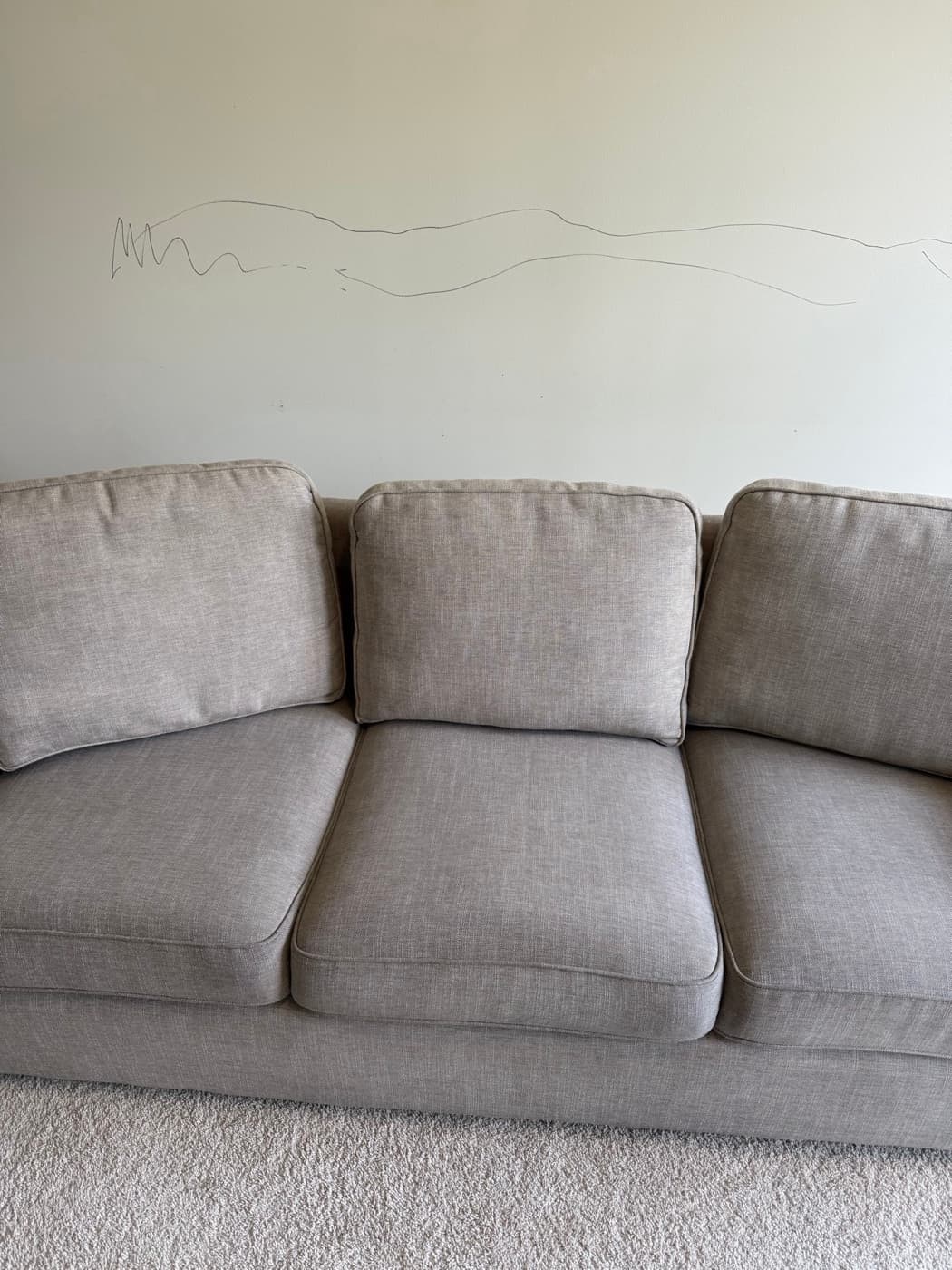 The same cream three-seat sofa after steam cleaning