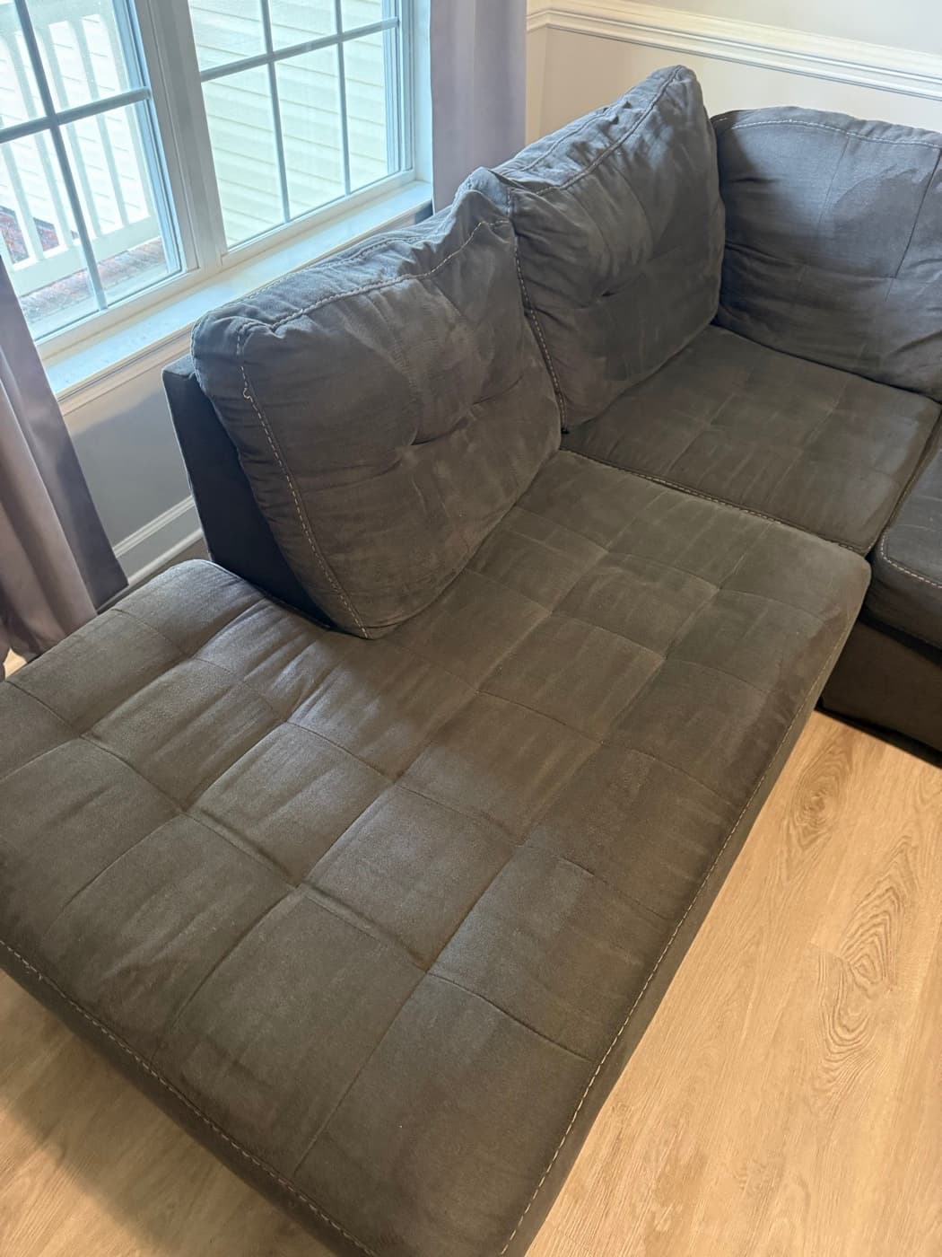 The same beige tufted sofa bed after steam cleaning
