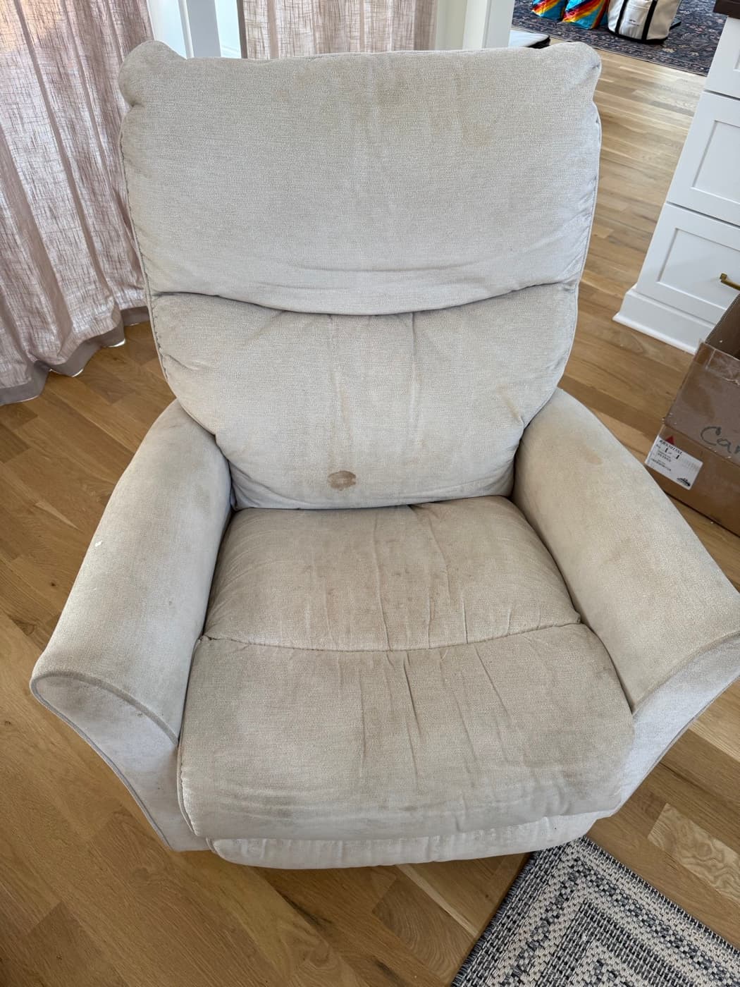 A cream armchair, before cleaning