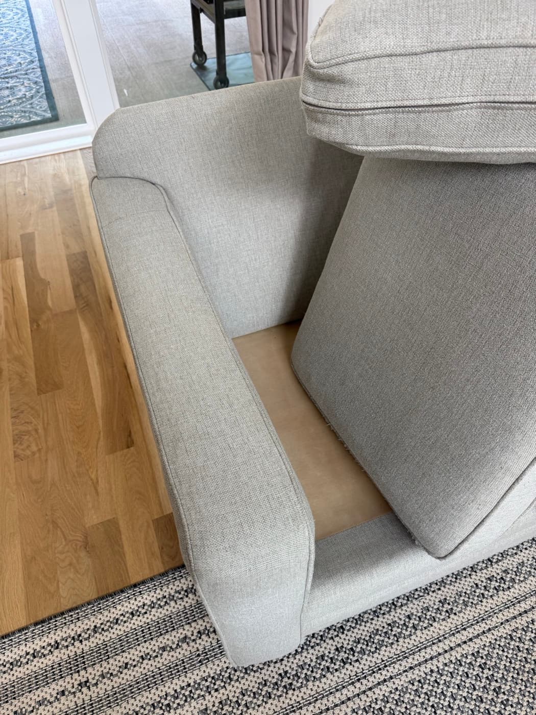The same grey chaise arm and seat after steam cleaning