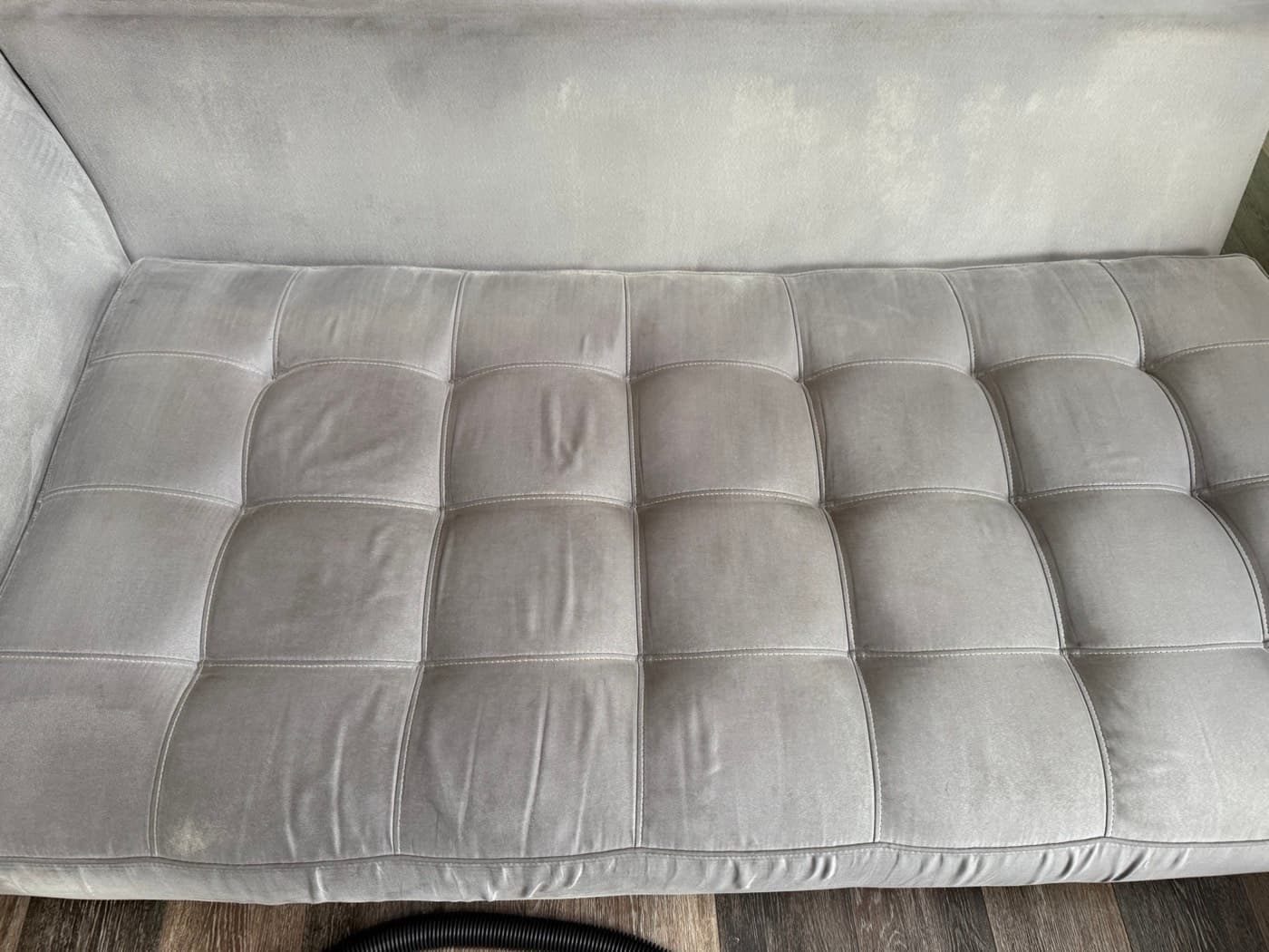 The same cream tufted sofa seat after steam cleaning