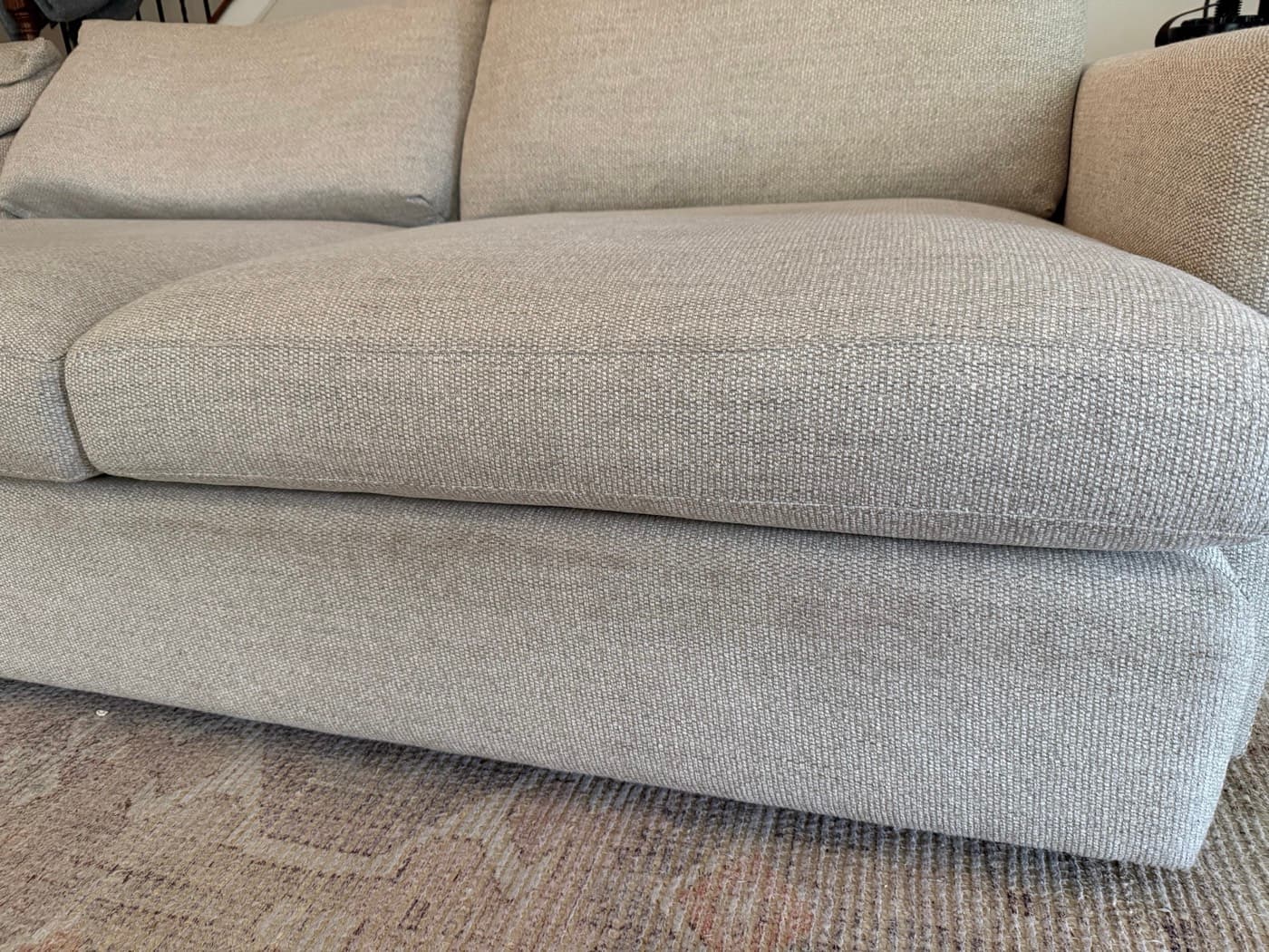 A light grey sofa with a chaise, before cleaning