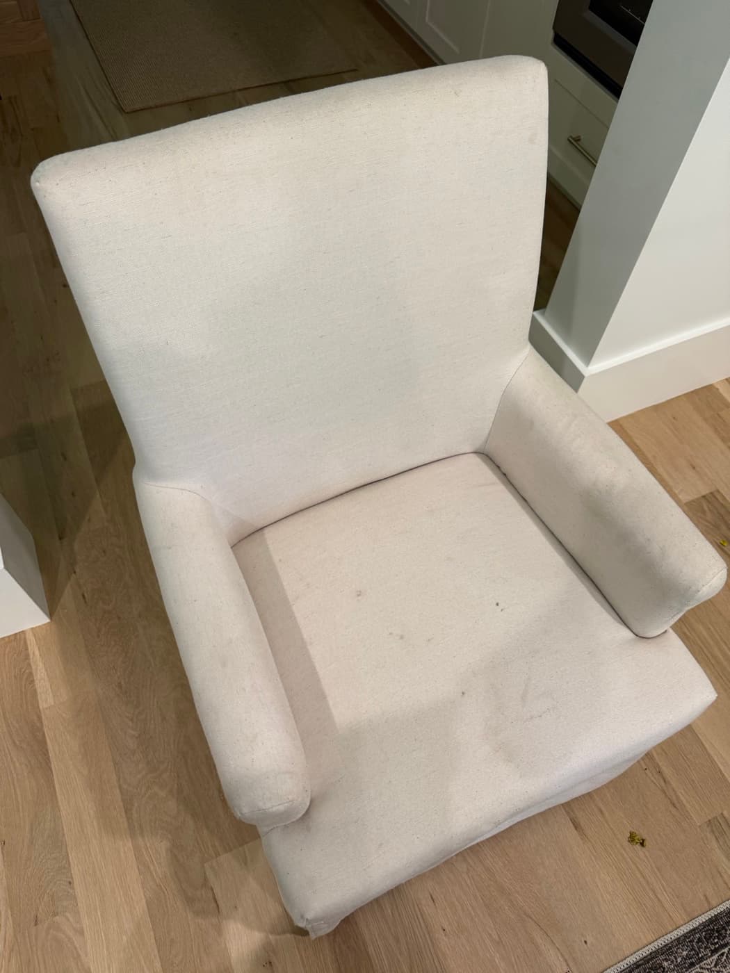 A cream recliner chair, before cleaning