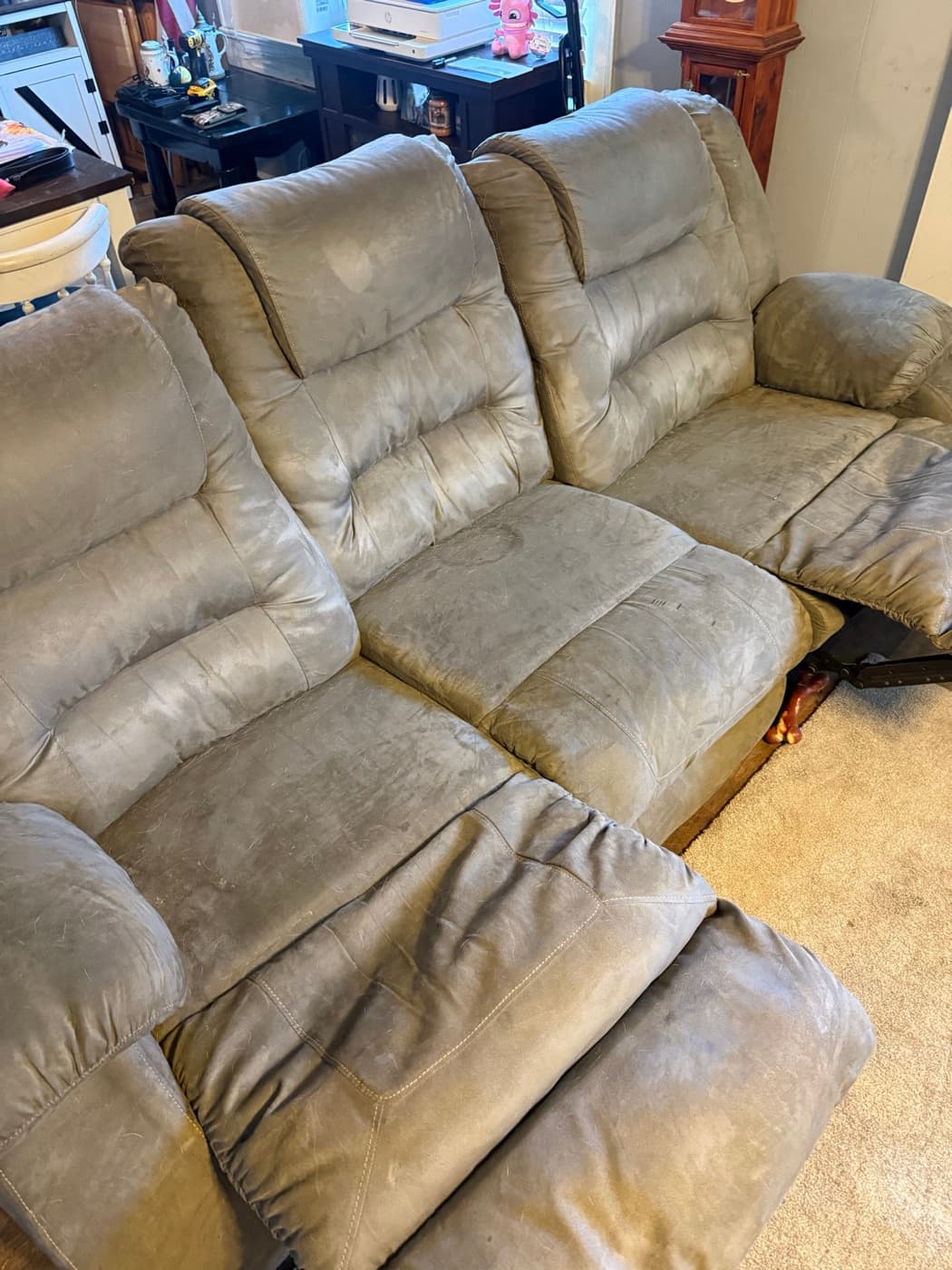 A taupe reclining sectional, before cleaning