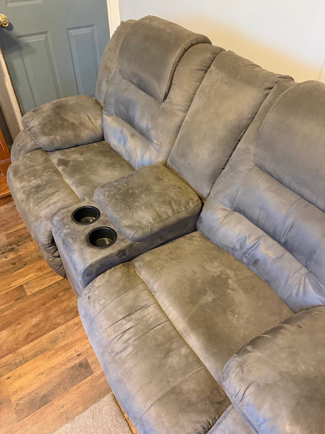 A taupe reclining sofa, before cleaning